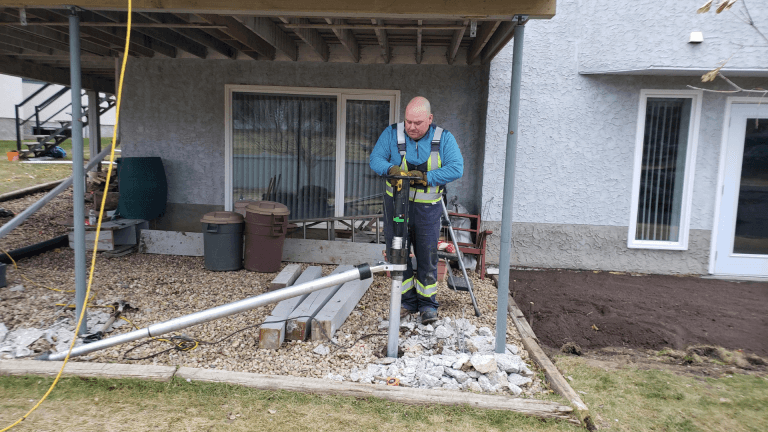 worker installing screw pile