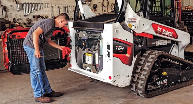 A man cleaning maintenance equipment