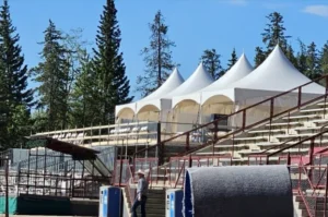 Outdoor festival with multiple event tents set up and people socializing